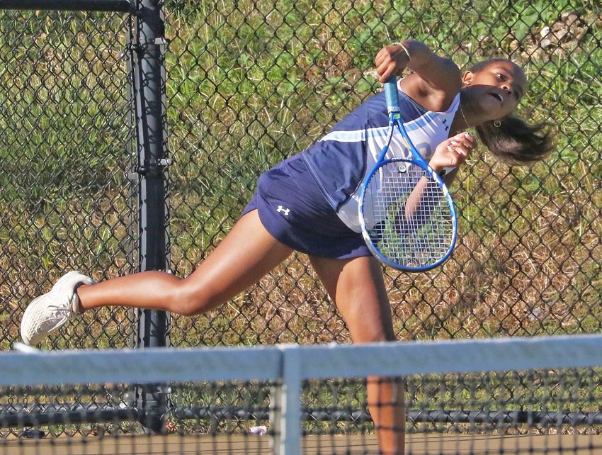 On her way to a pivotal victory, SCH sophomore Ameara Smith follows through on a serve in the third singles match.